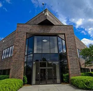 A brick building with a large clock on the front
