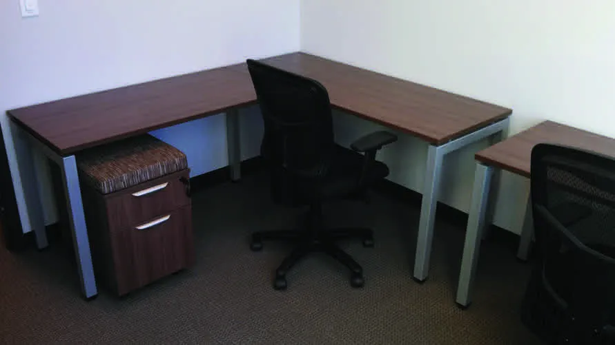 A desk with a laptop and a chair