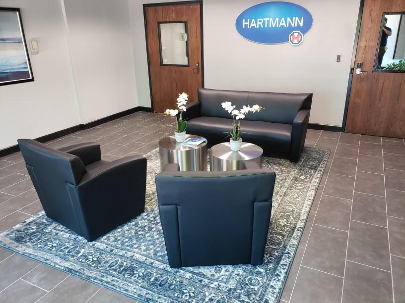 A living room with a couch chair and a table