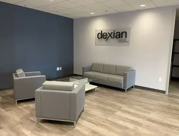 A living room with a couch chair and a table