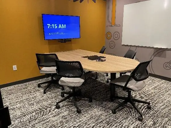 A room with a table and a tv