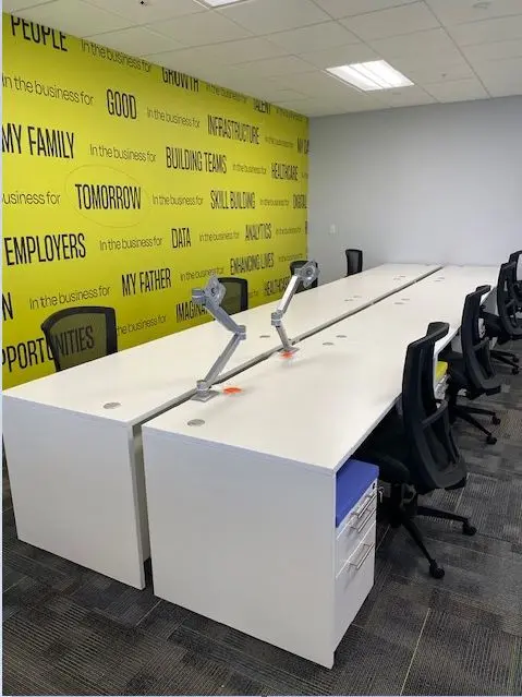 A white desk with a white wall and a yellow wall