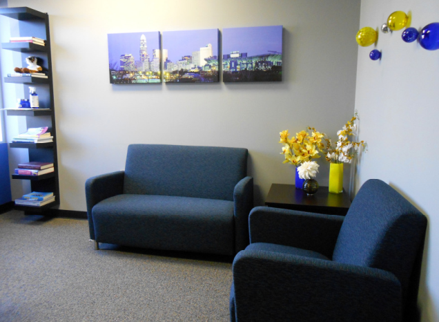 A living room with a couch chair and a table